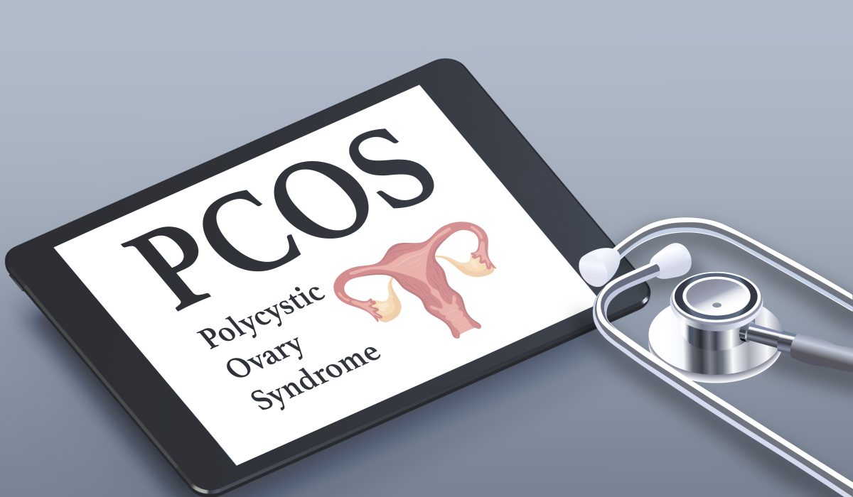PCOS, polycystic ovary syndrome, uterus text and icon on tablet with stethoscope. Gray background. Medical poster. High quality photo