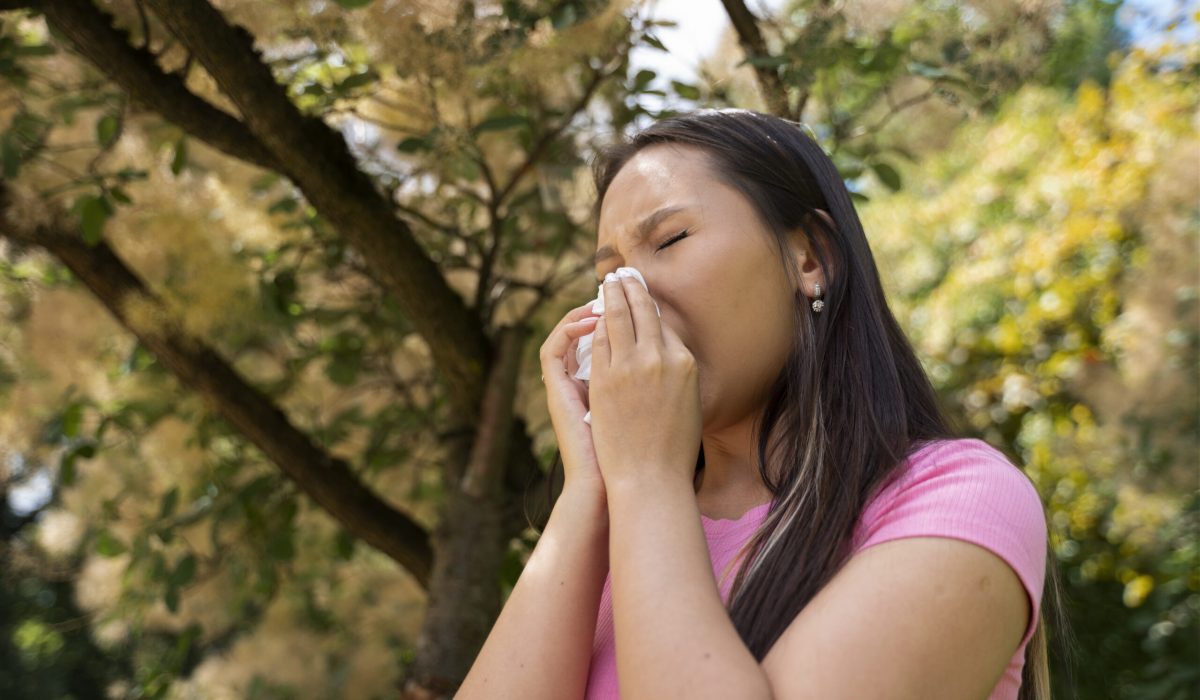 low-angle-woman-blowing-her-nose
